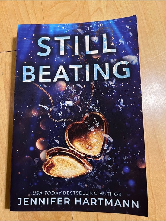 Other - Still Beating by Jennifer Hartmann - Dark Blue Cover with Gold Heart Locket